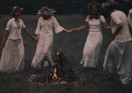 Witchy women dancing around fire